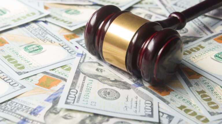 Gavel on the dollar cash background