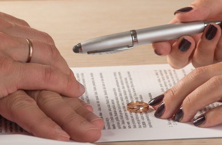 Wife and husband signing divorce documents