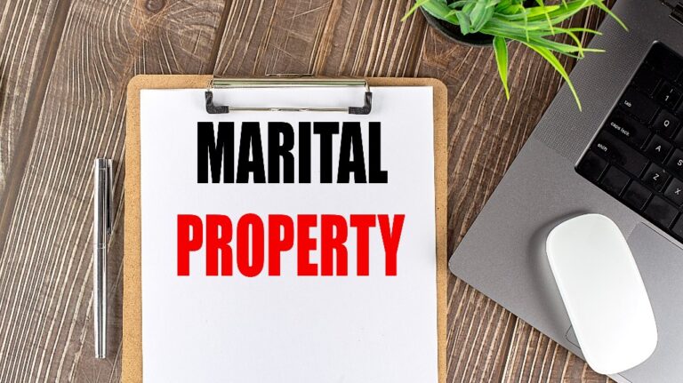 Marital Property text on a clipboard paper with laptop, mouse and pen