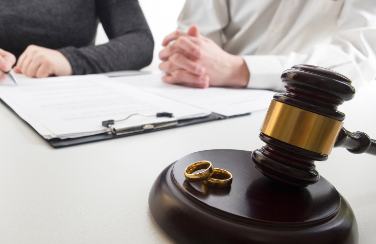 Hands of wife, husband signing decree of divorce