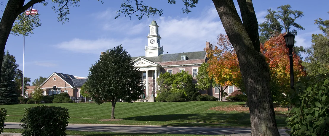 A large building featuring a prominent clock tower atop its structure.