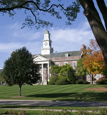 A large building featuring a prominent clock tower atop its structure.