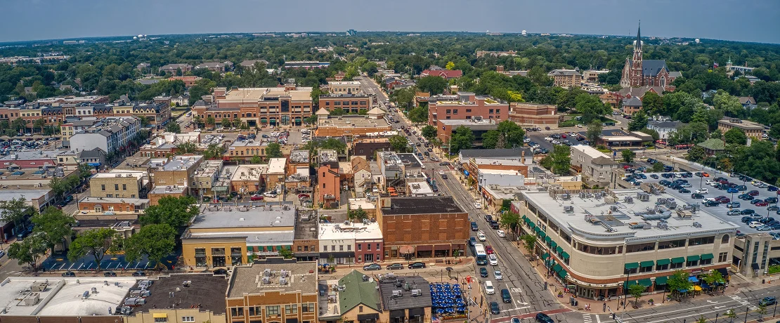 Aerial view of downtown Charlottesville, Virginia, showcasing city buildings and streets from above.