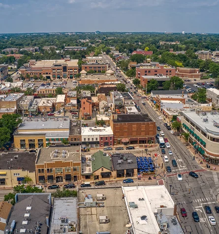 Aerial view of downtown Charlottesville, Virginia, showcasing city buildings and streets from above.