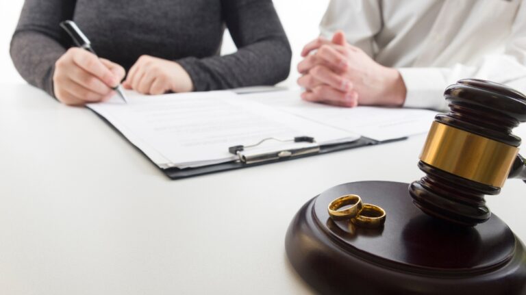 Hands of wife, husband signing decree of divorce