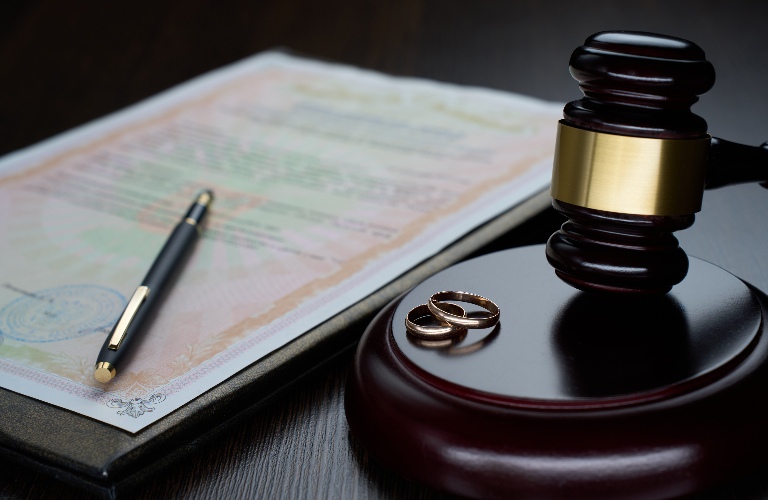 Judge's gavel and wedding rings
