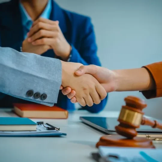 Attorneys and clients meeting around a table in a collaborative divorce session