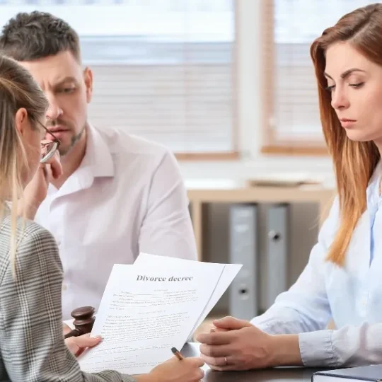 A couple meeting with a family law attorney in an office