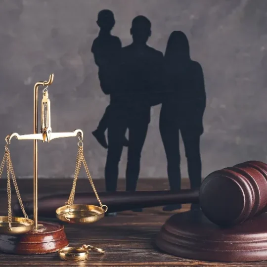 Silhouette of a family beside a set of legal scales, representing an Illinois family law case